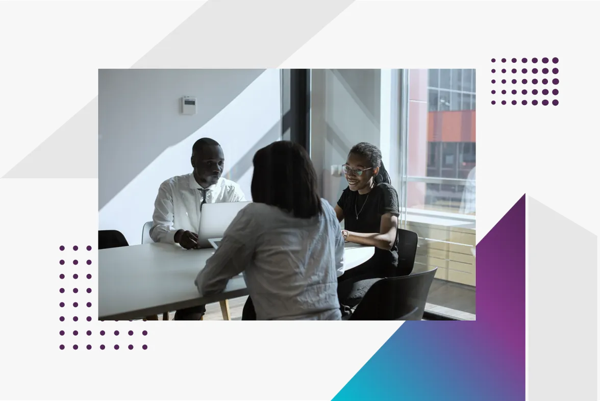 Three colleagues talking around a meeting table