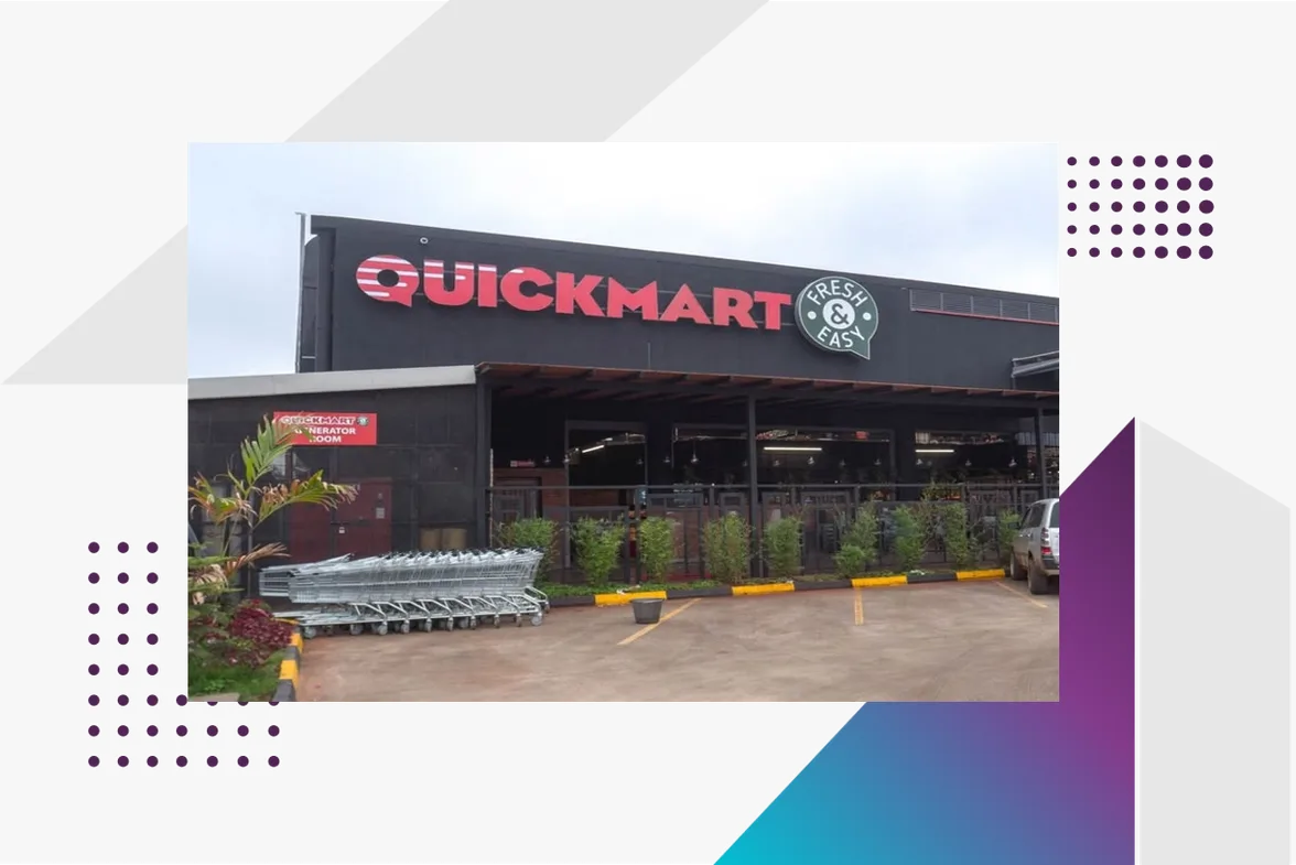 The front of a Quickmart supermarket in Kenya, with shopping trolleys outside